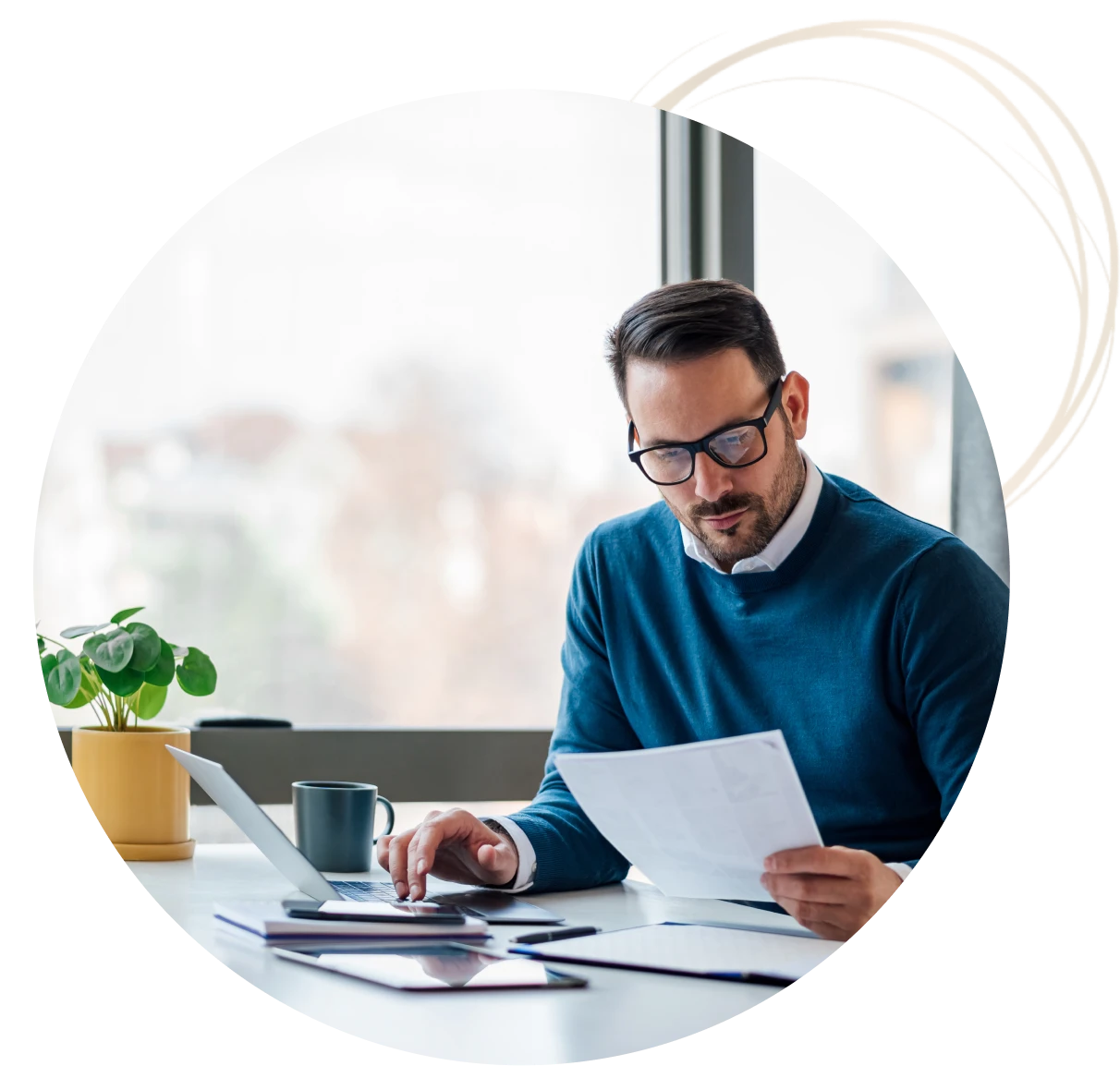Professional reviewing documents near window